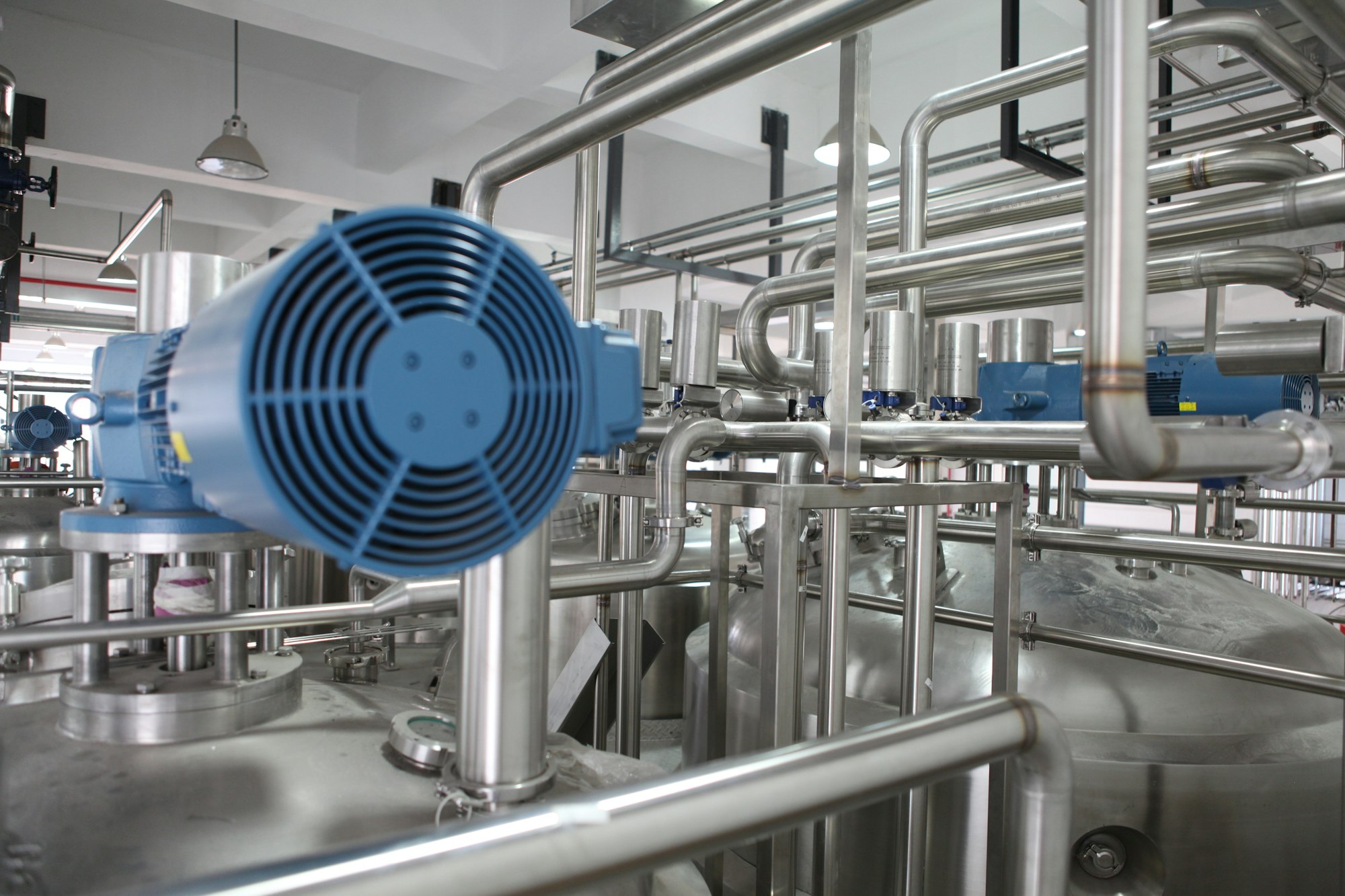 Process plant piping and motors on a factory floor